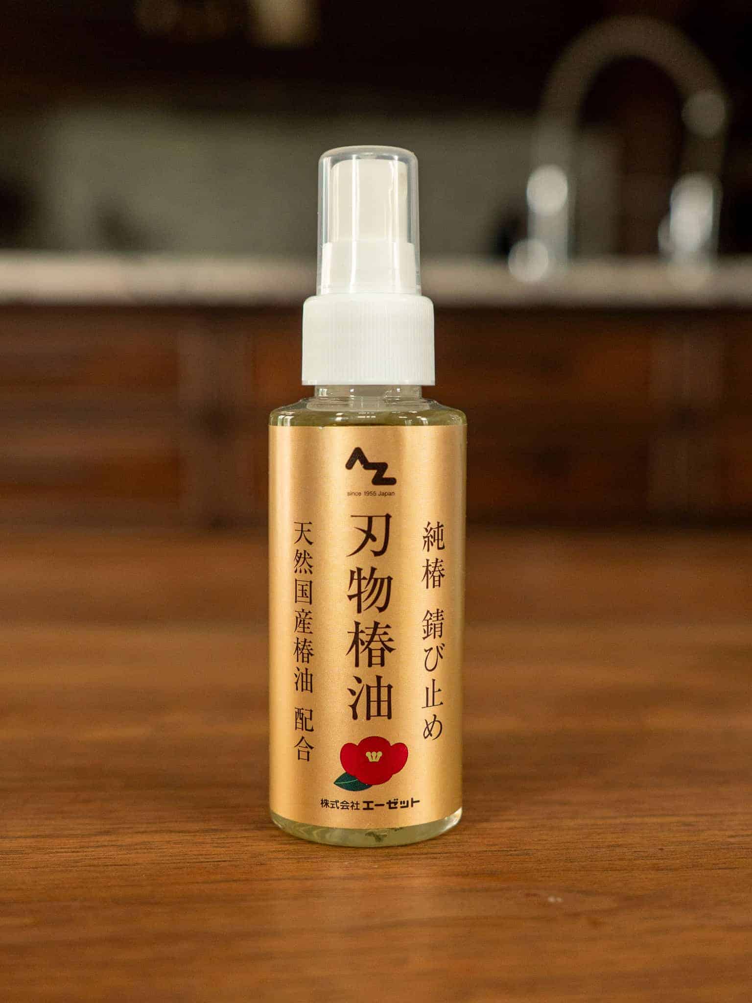 Bottle of Japanese Camellia oil on a wooden surface with a blurred background