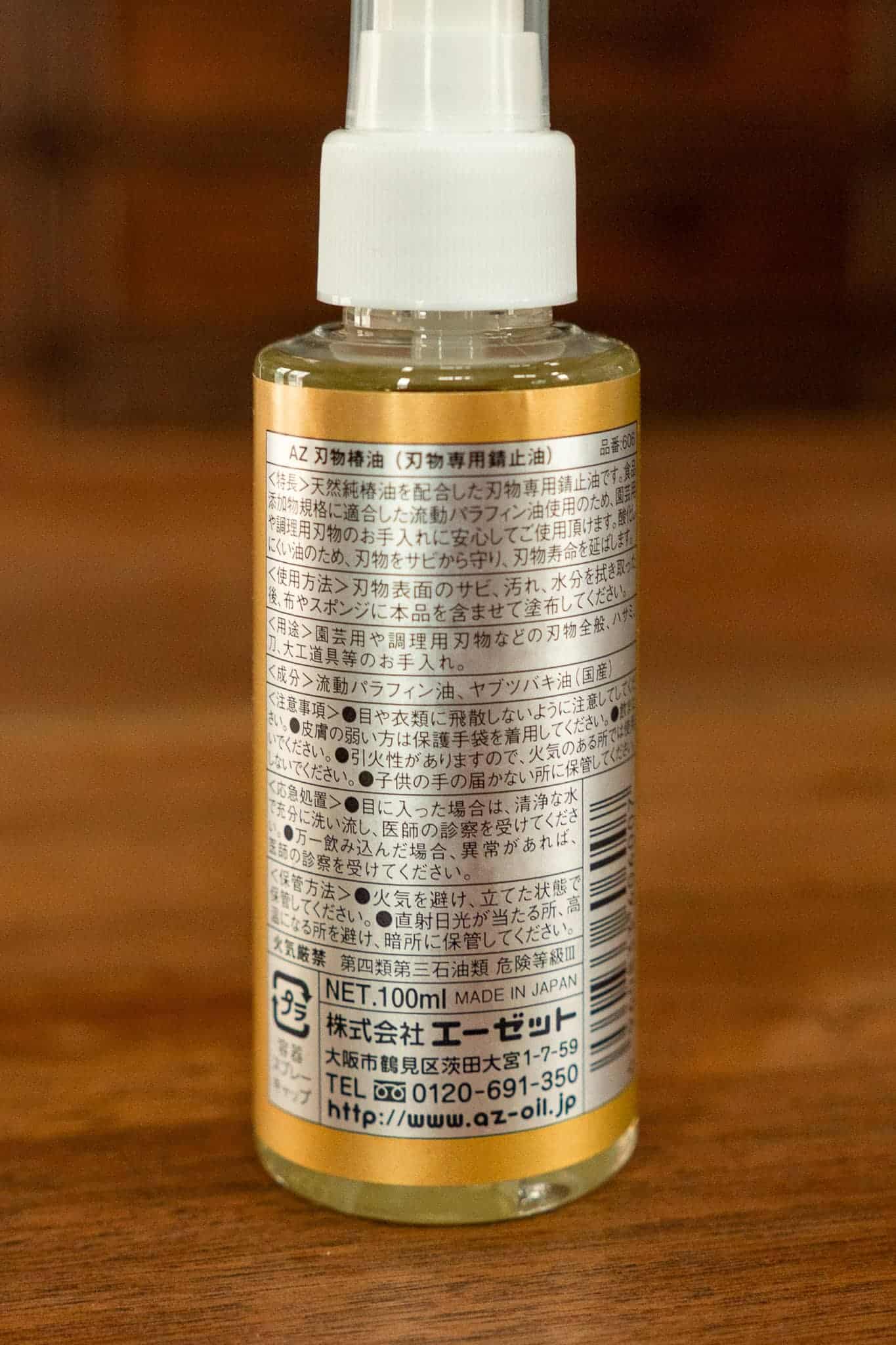 Bottle of Camellia oil with a label on a wooden surface