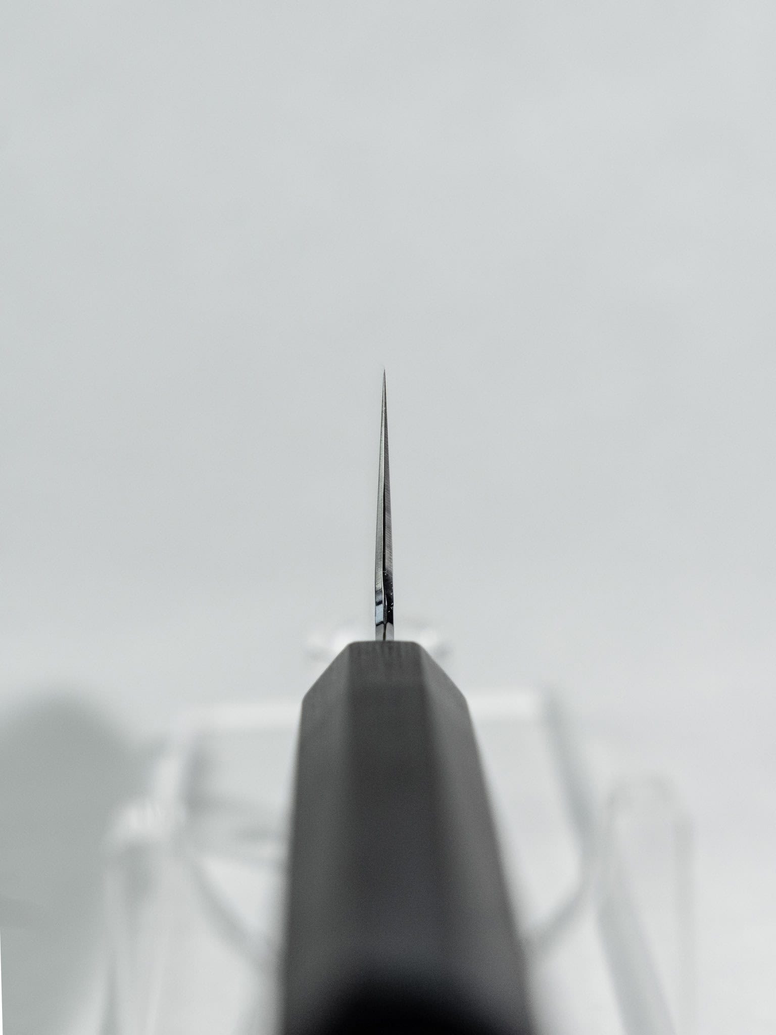 Choil shot of Hado Shiosai Ko-Bunka 135mm showing SPG2 core, stainless cladding layers, and polished bevels at 2mm spine thickness