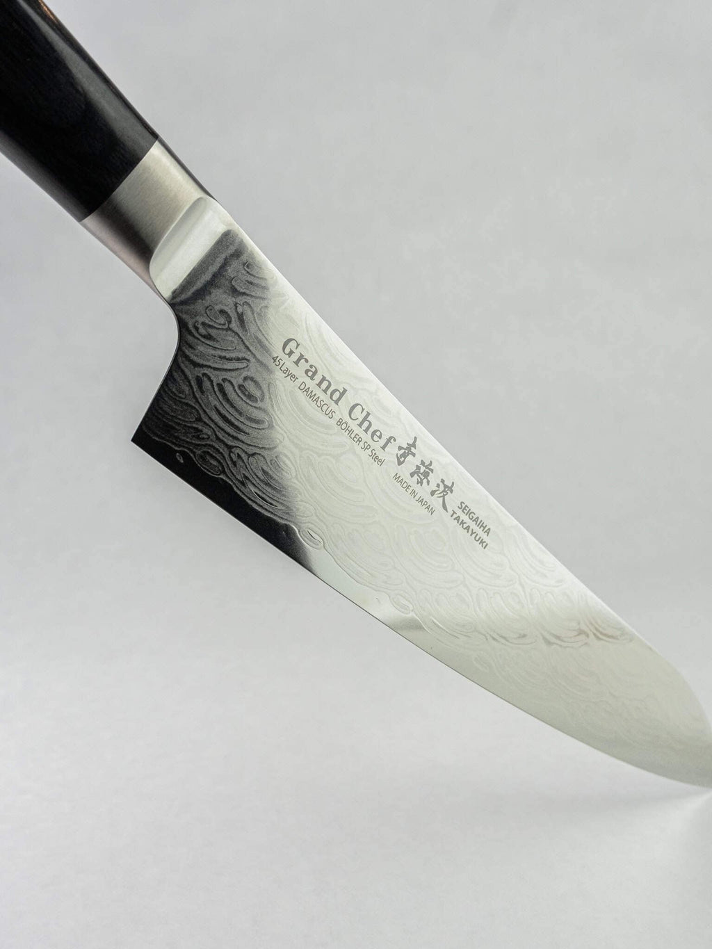 Stainless Damascus tsuchime cladding on Gyuto knife.
