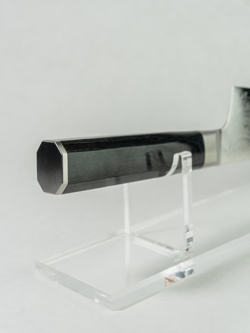 Close-up of black pakka wood handle on Sakai Takayuki Kengata.