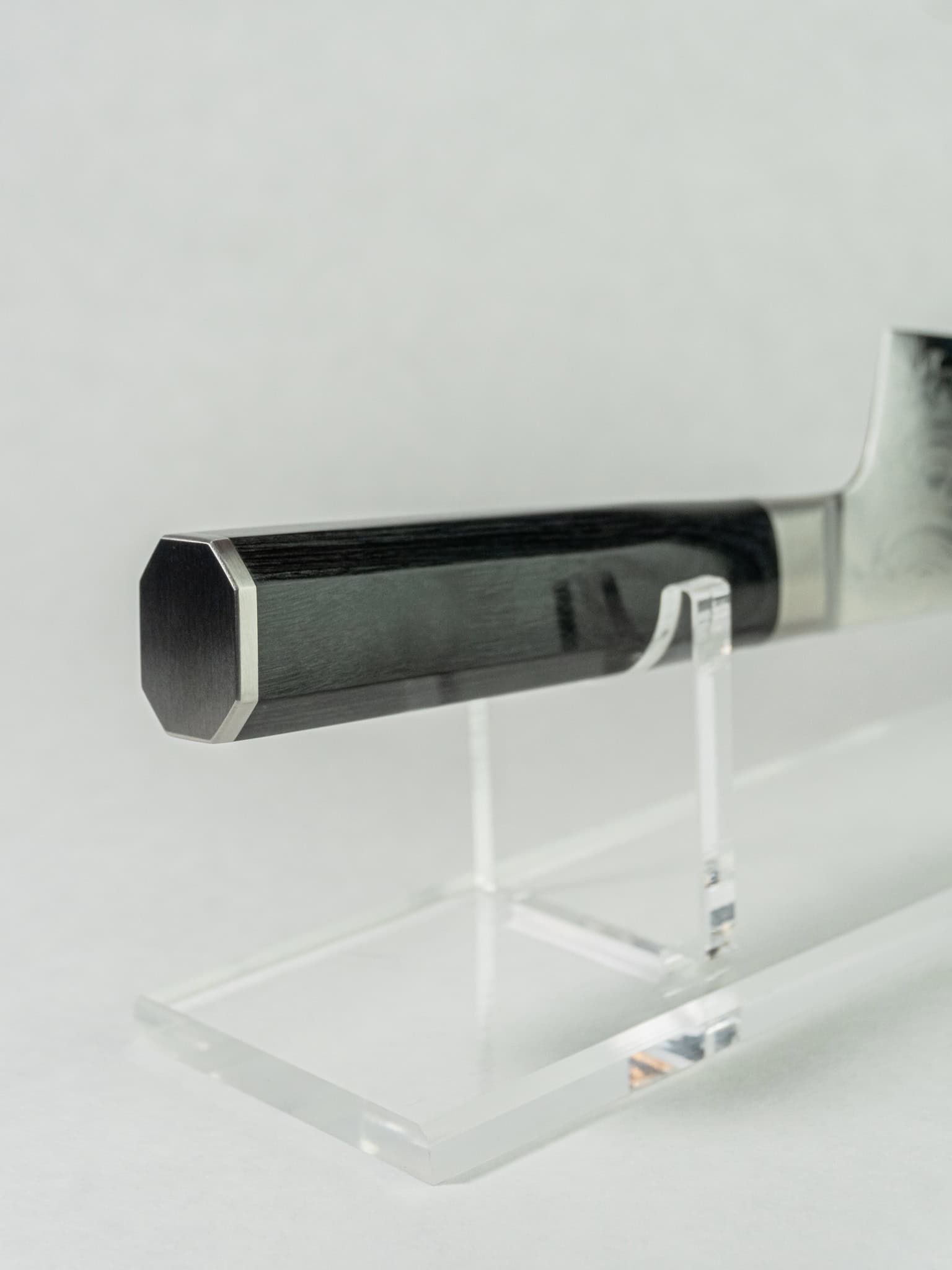 Close-up of black pakka wood handle on Sakai Takayuki Kengata.