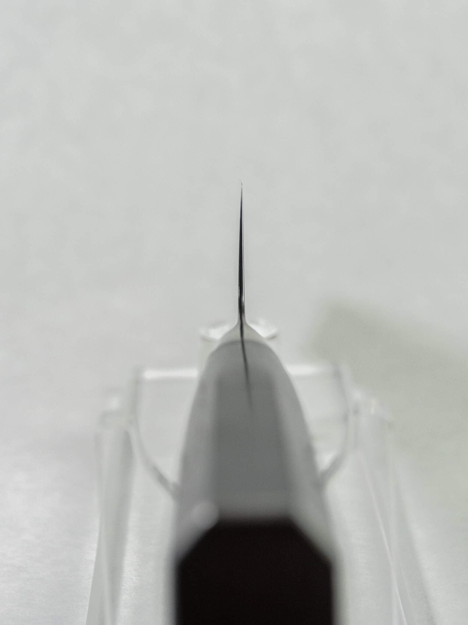 Thin choil thickness for reduced cutting resistance shown on a contrasted white background.
