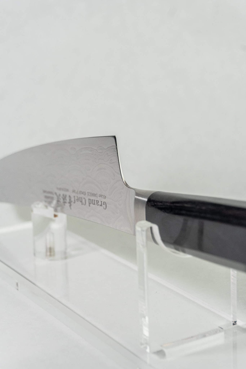 Stainless steel kengata knife with a black handle on a white background. Side of the knife is printed with "grand chef"