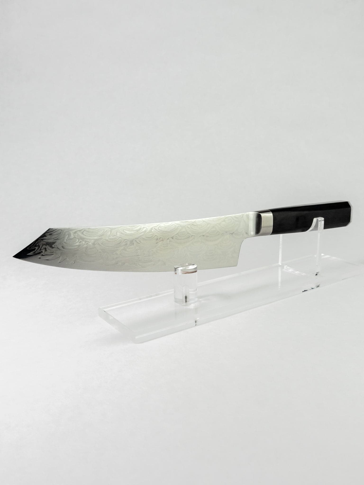 Full profile view and fit and finish details on Sakai Takayuki Seigaiha Kengata on a clear stand.
