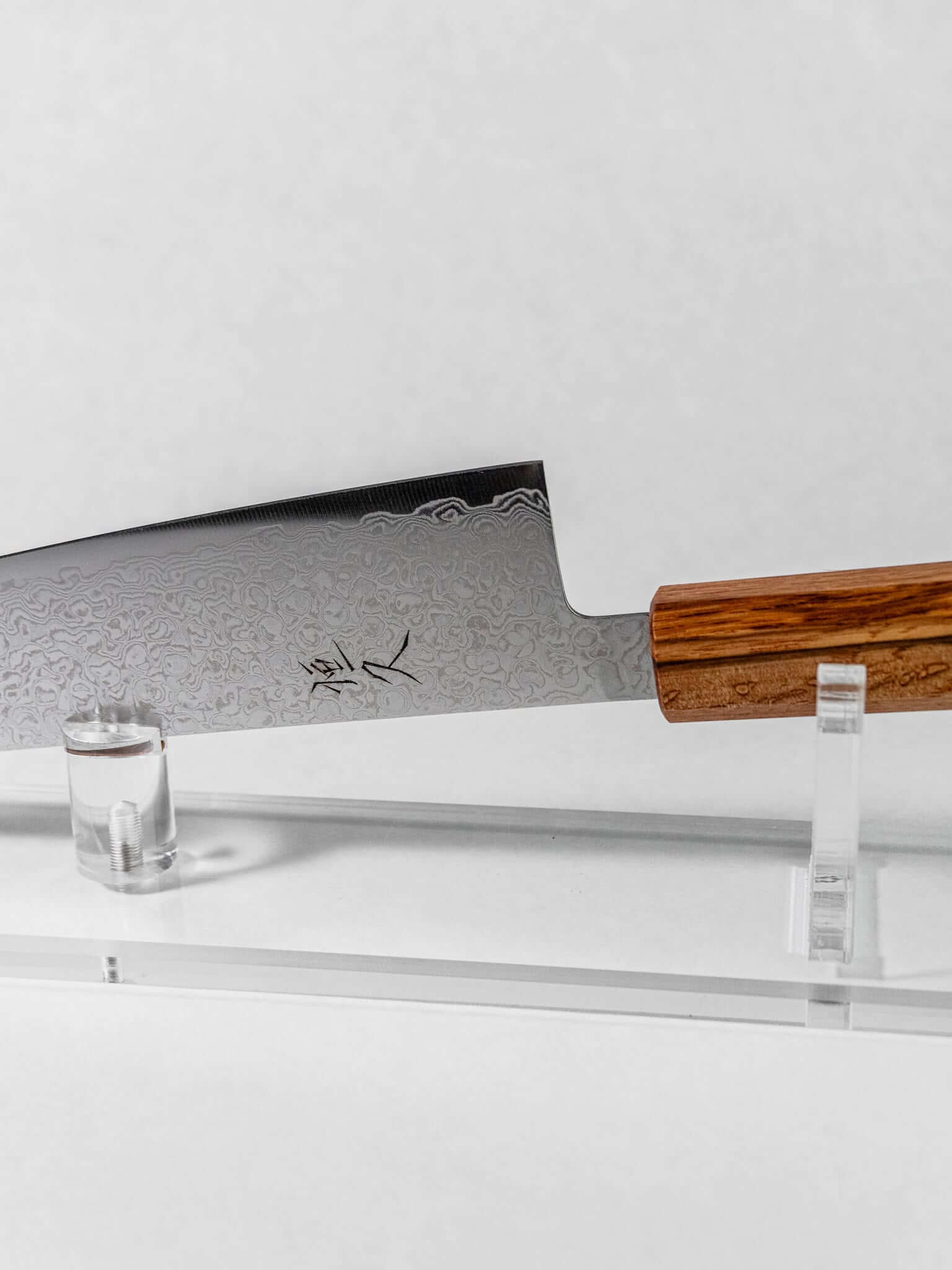 Balanced lightweight feel of Tsunehisa ZA-18 santoku. Close up of the balance point where the blade meets the handle.