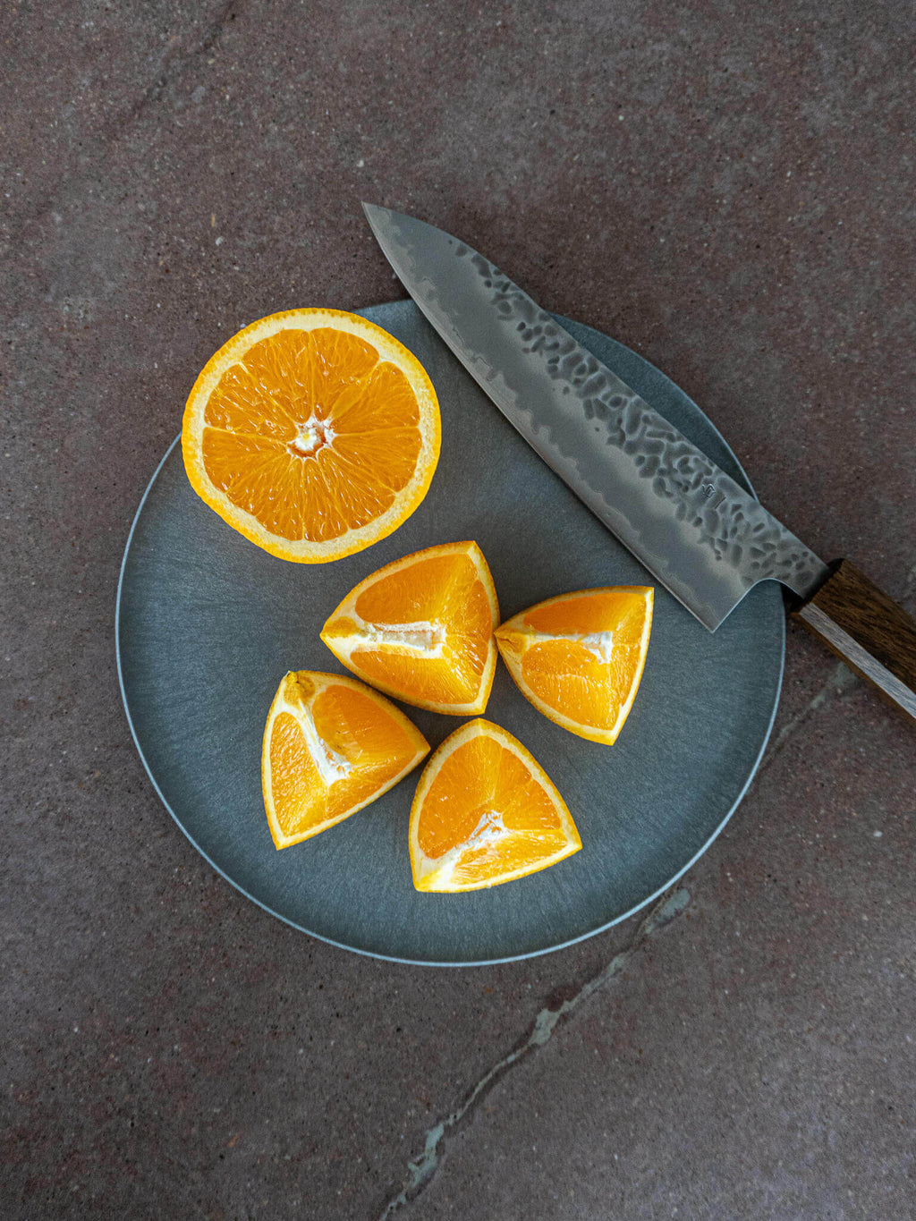 CHOPLATE in use for slicing fruit and snacks, allowing food to be eaten directly from the board.