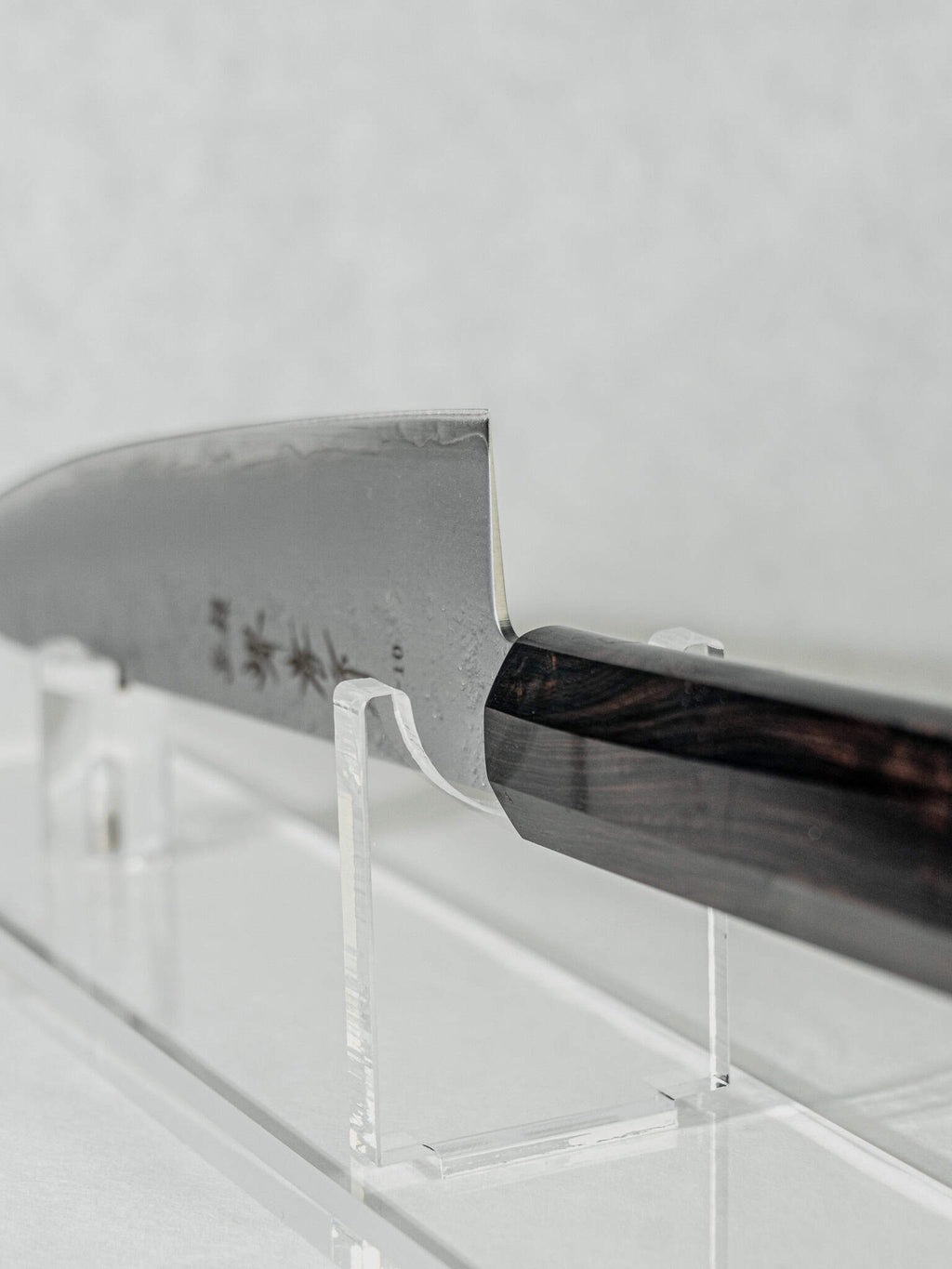Close-up showing the sharp VG-10 core edge, choil, and the pinch grip section of the Gyuto knife’s hybrid octagonal ebony handle