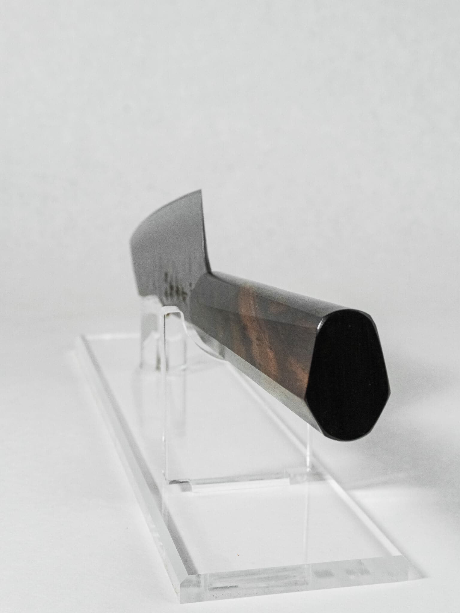 Hybrid octagonal ebony handle on Sakai Takayuki Kengata knife shown from the back.