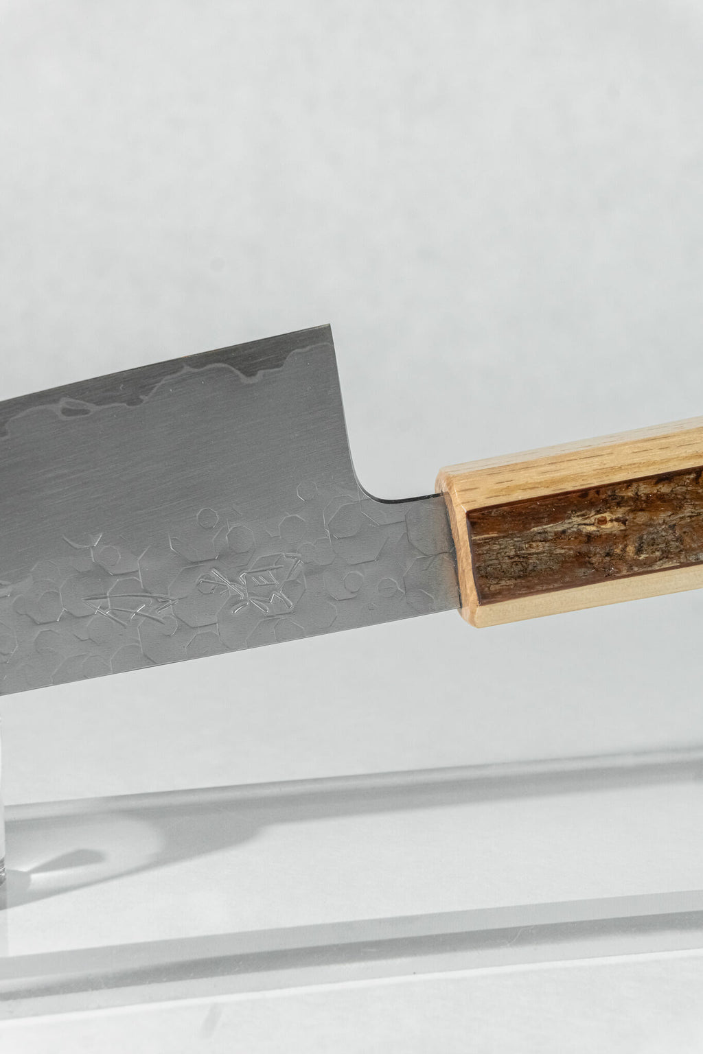 Pinch grip detail highlighting refined Japanese blade geometry and a perfectly balanced blade-to-handle transition