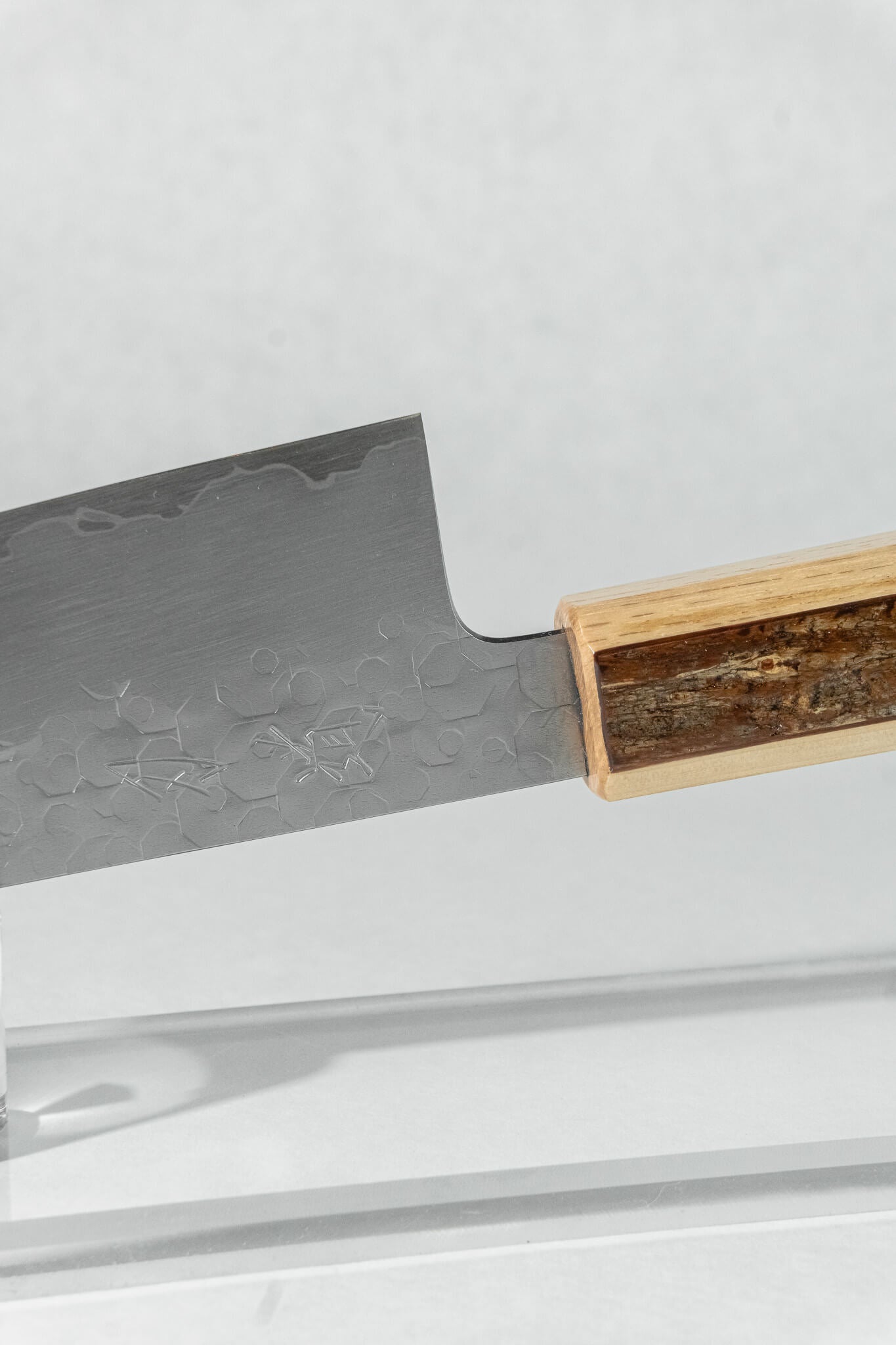 Pinch grip detail highlighting refined Japanese blade geometry and a perfectly balanced blade-to-handle transition