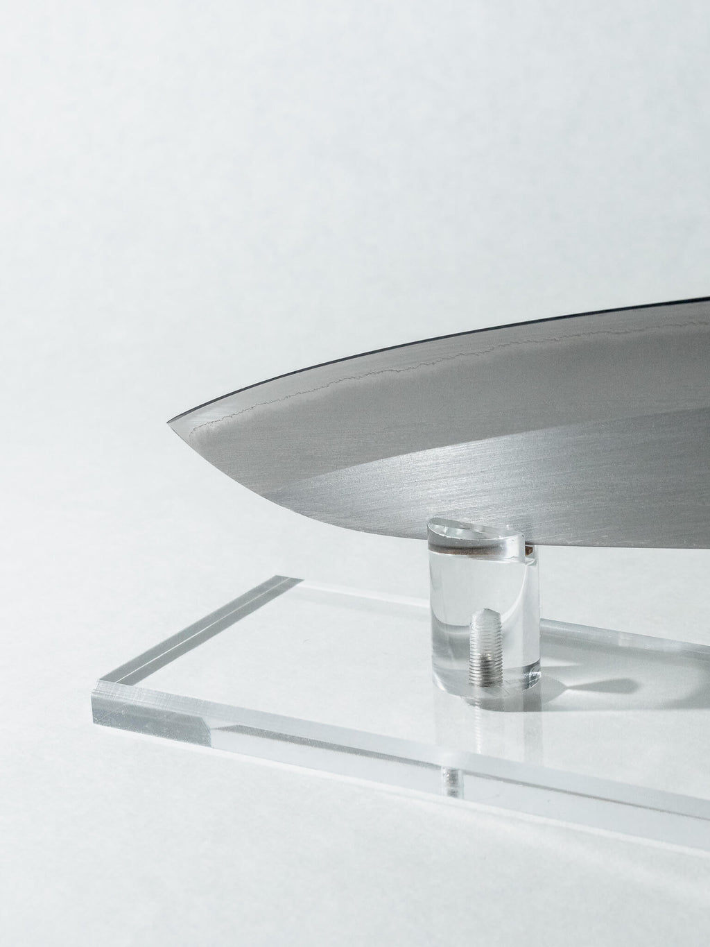 Detail of OUL Santoku blade tip highlighting high-carbon White #1 steel and polished kasumi surface