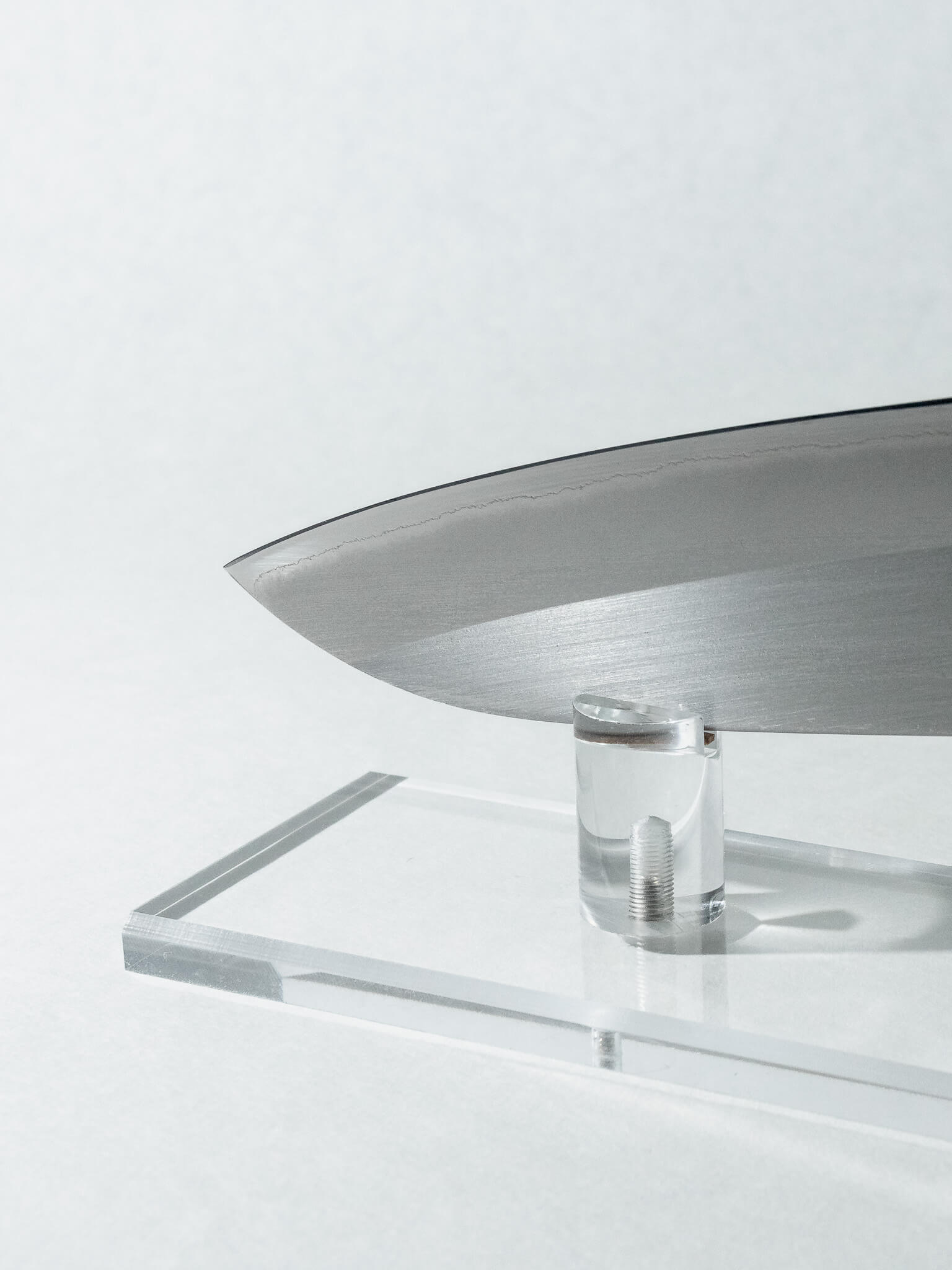 Detail of OUL Santoku blade tip highlighting high-carbon White #1 steel and polished kasumi surface