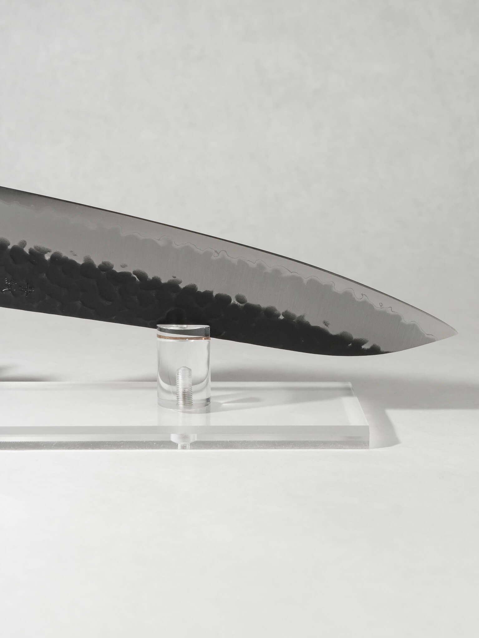 Close-up of OUL Gyuto tip showing sharp point and precision cutting edge.