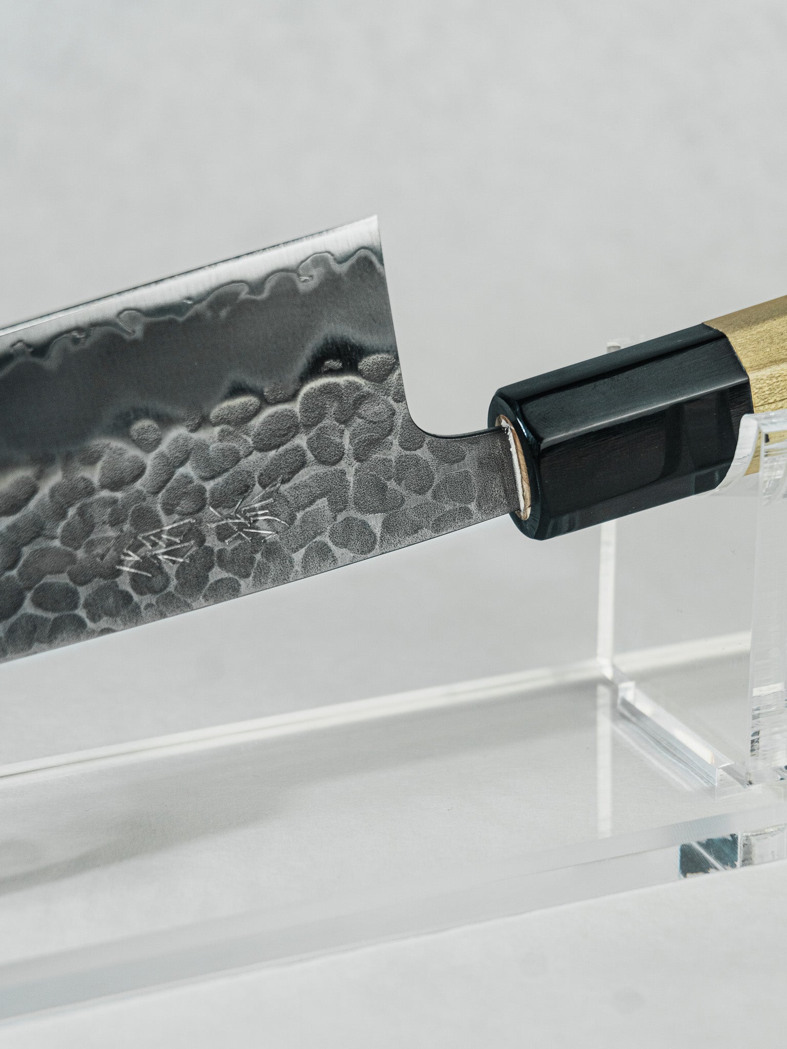 Close-up of Aogami Super Santoku blade featuring hand-hammered tsuchime finish for improved food release.