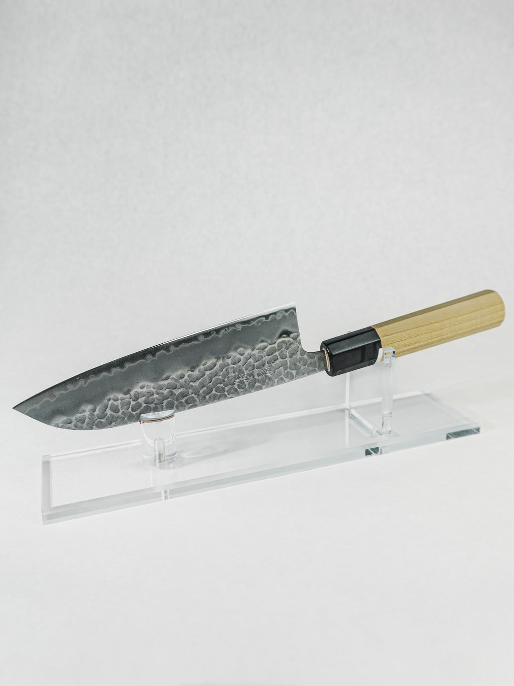 OUL 180mm Santoku knife with Aogami Super core, stainless tsuchime cladding, and octagonal magnolia handle with buffalo horn ferrule.