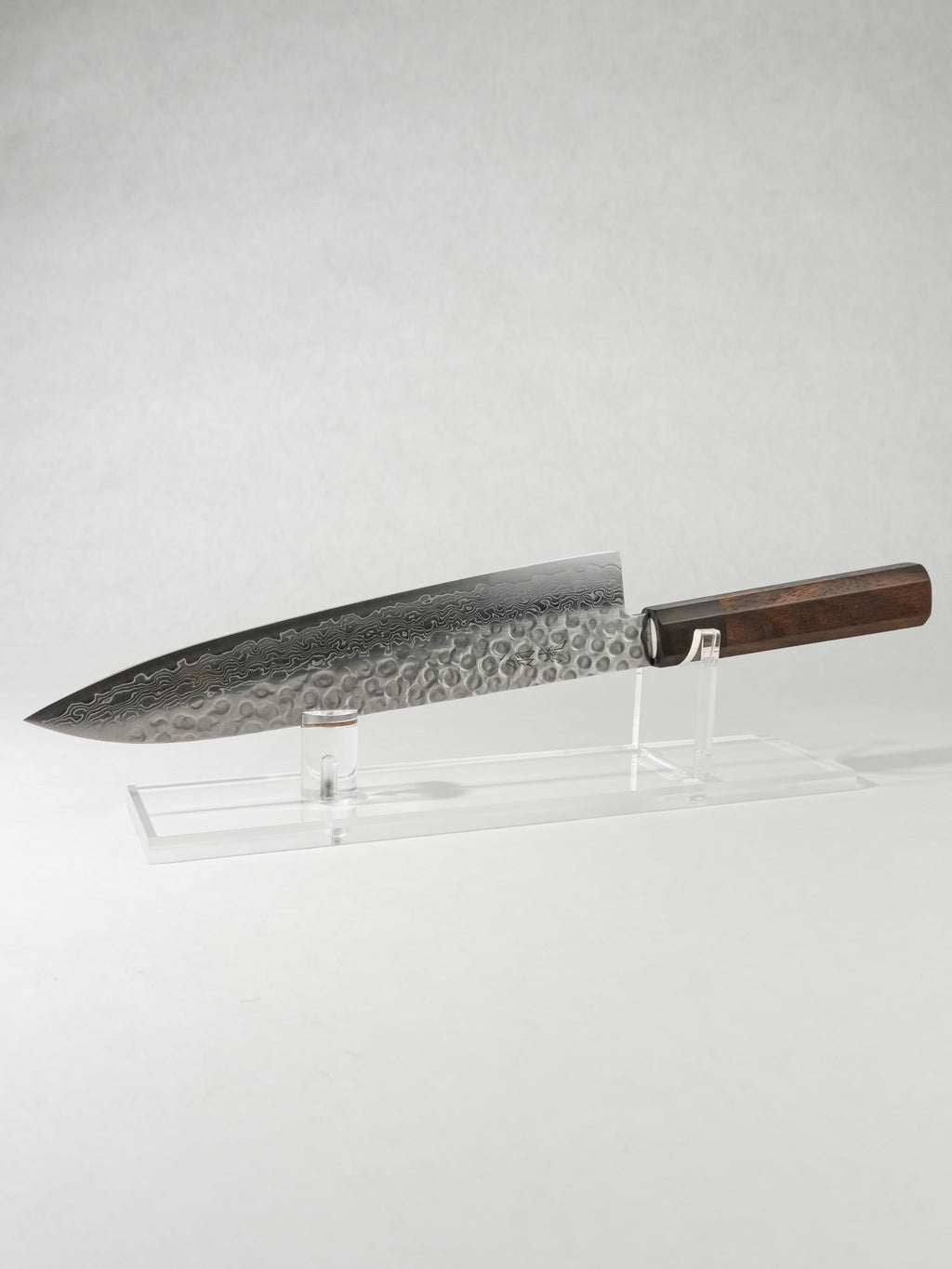 OUL 210mm Gyuto knife with AUS-10A core, stainless Damascus tsuchime cladding, etched kanji, and octagonal rosewood handle.