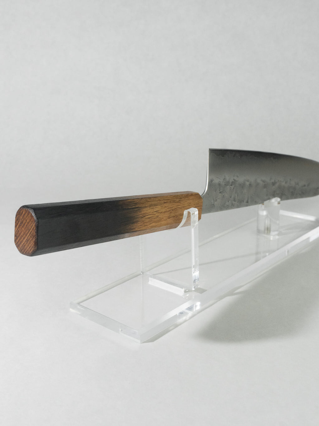 Handle close-up of the OUL Gyuto chef knife highlighting the natural gradient created by the burnt oak finish