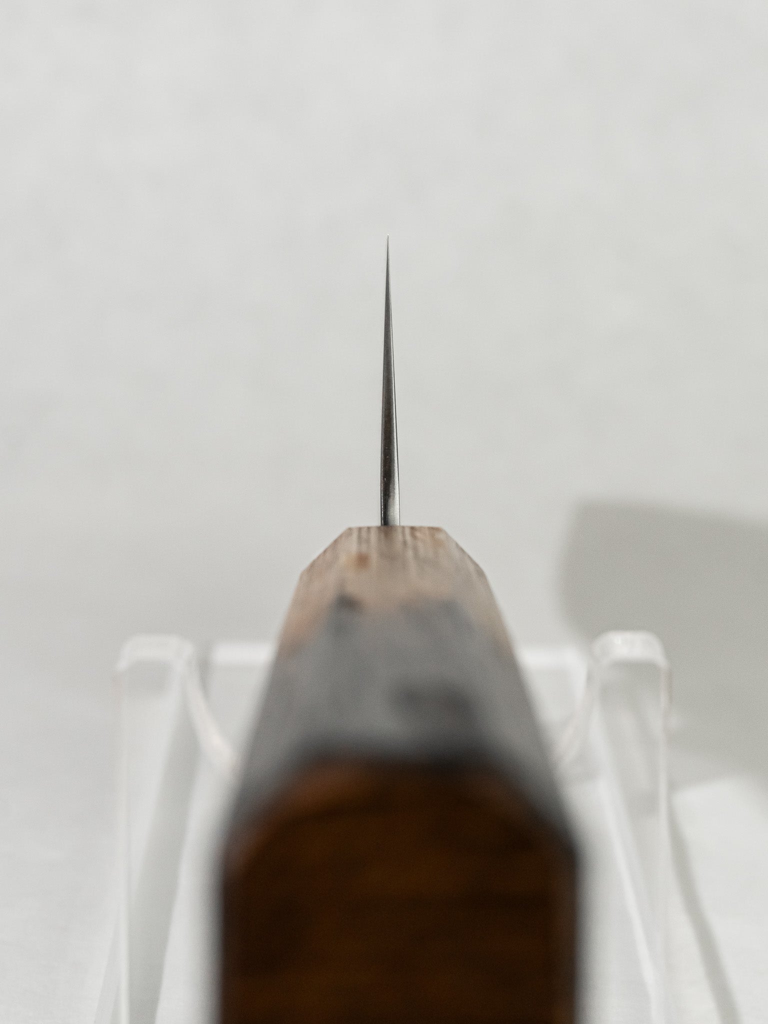 Choil close-up on OUL Ginsan Gyuto for enhanced control and smooth pinch grip.
