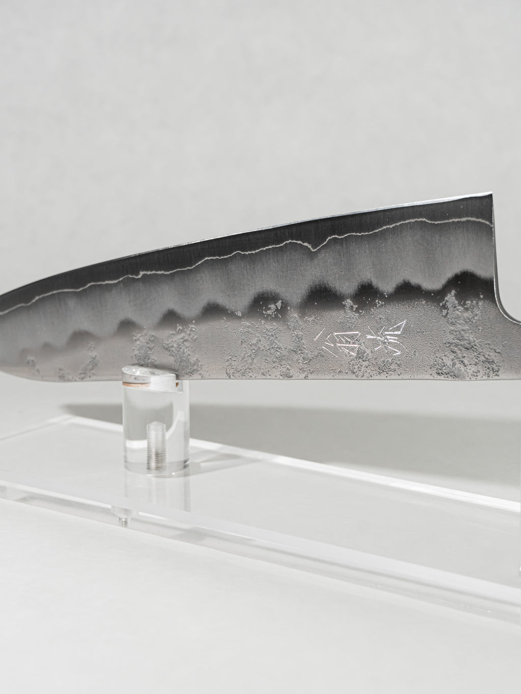Close-up of Ginsan steel Gyuto blade with stainless nashiji finish for improved food release.