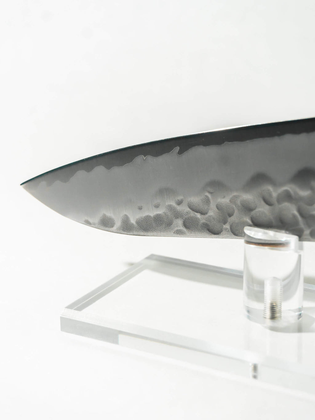 Detail of hand-hammered tsuchime texture for improved food release as well as the sharp tip of the knife.
