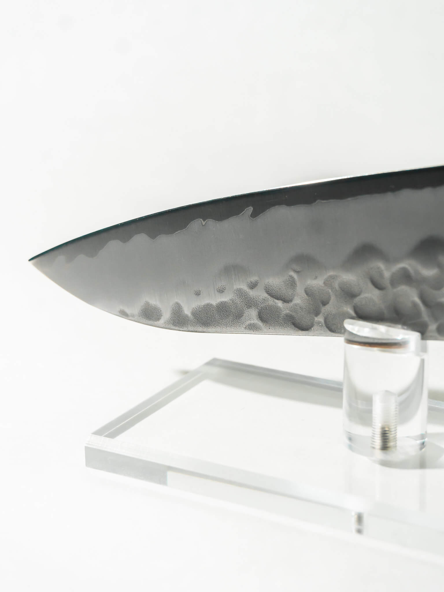 Detail of hand-hammered tsuchime texture for improved food release as well as the sharp tip of the knife.