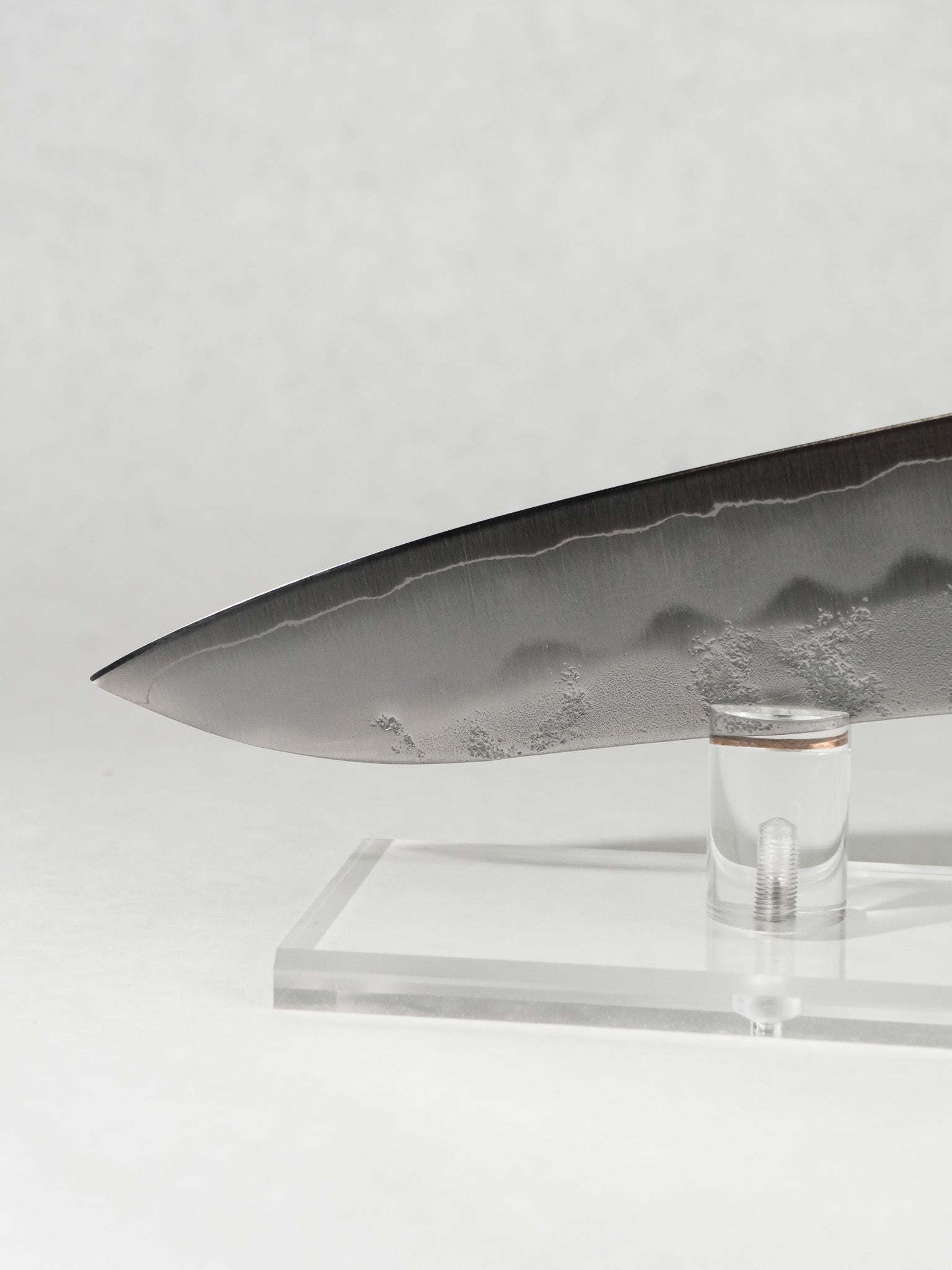 Gyuto tip close-up showing precise geometry for slicing and detailed prep work.