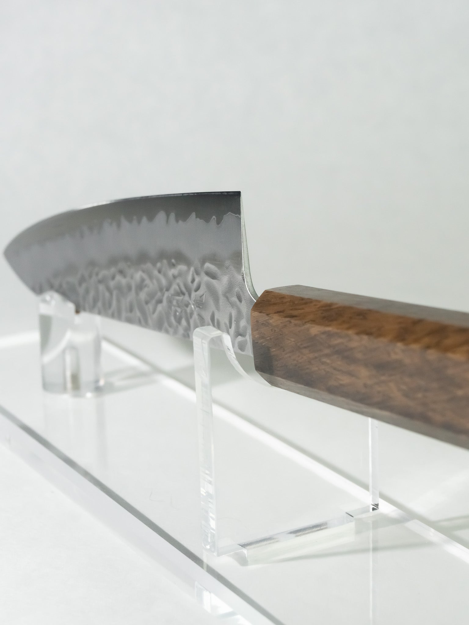 Side profile of OUL 180mm Gyuto showing full tsuchime blade and darkened oak handle.