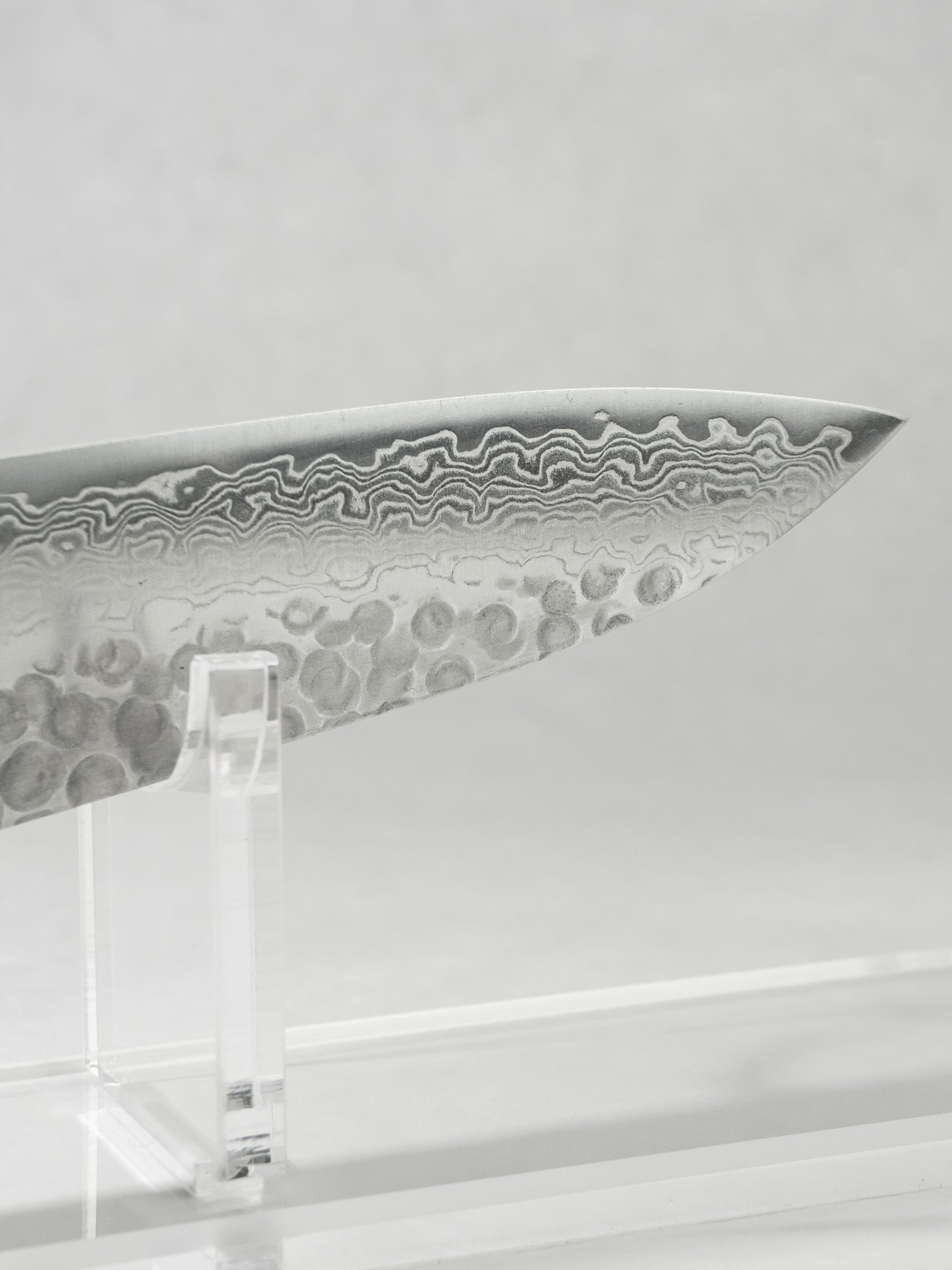 Gyuto tip close-up showing precise geometry for controlled slicing and push cutting.