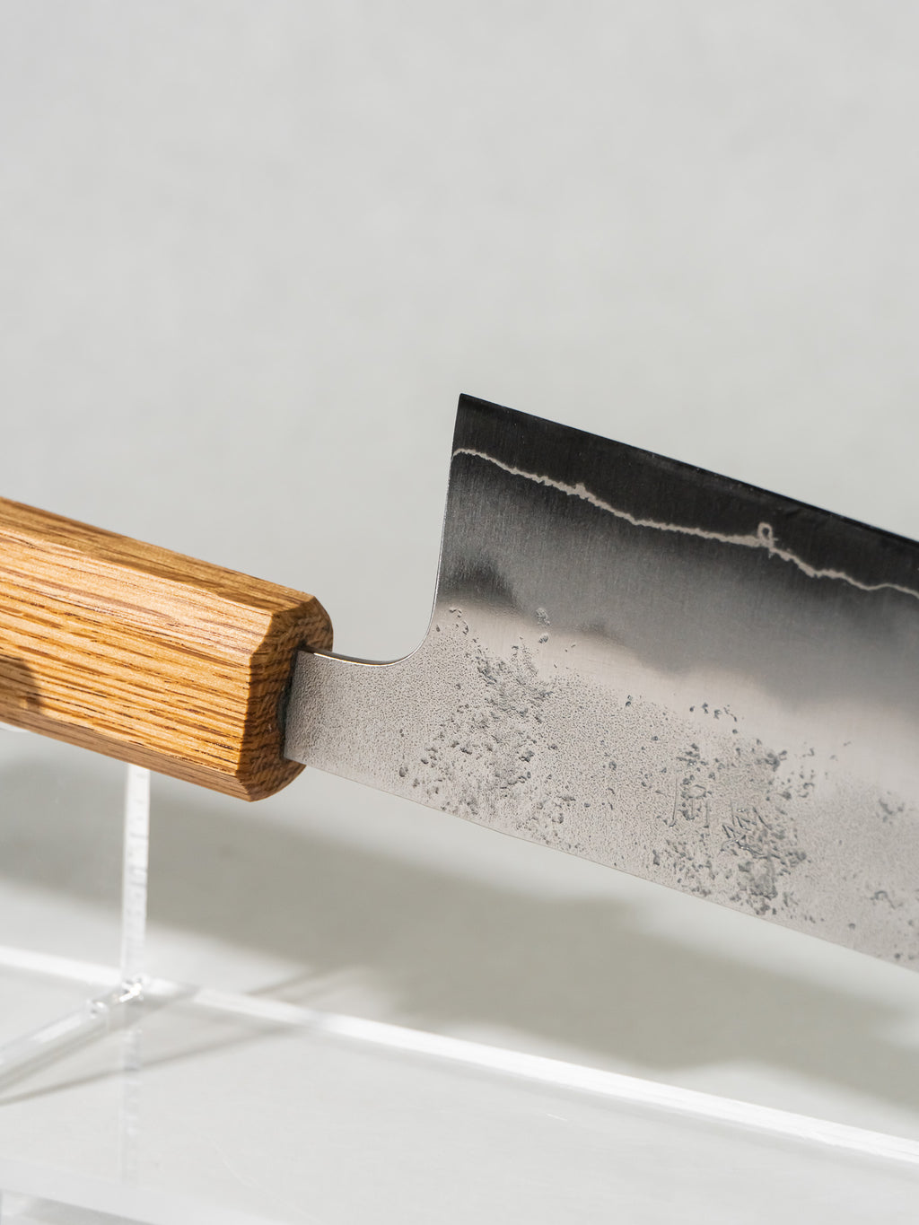 Detail of nashiji pear-skin texture highlighting traditional Japanese craftsmanship and edge detail highlighting razor-sharp Ginsan steel and fine grind.

