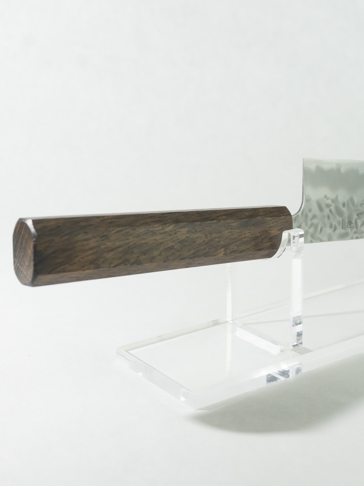 Close-up of octagonal darkened oak handle for ergonomic and balanced grip. Detail of handle craftsmanship highlighting smooth finish for precise pinch grip.