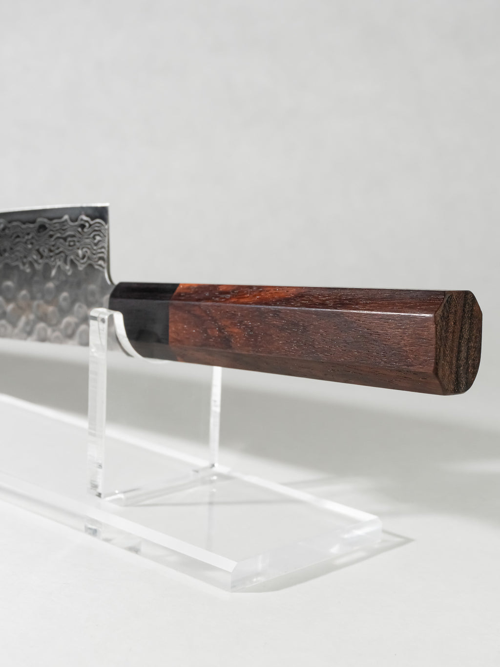 Close-up of octagonal rosewood handle with black pakkawood ferrule, offering comfort, stability, and refined aesthetics.