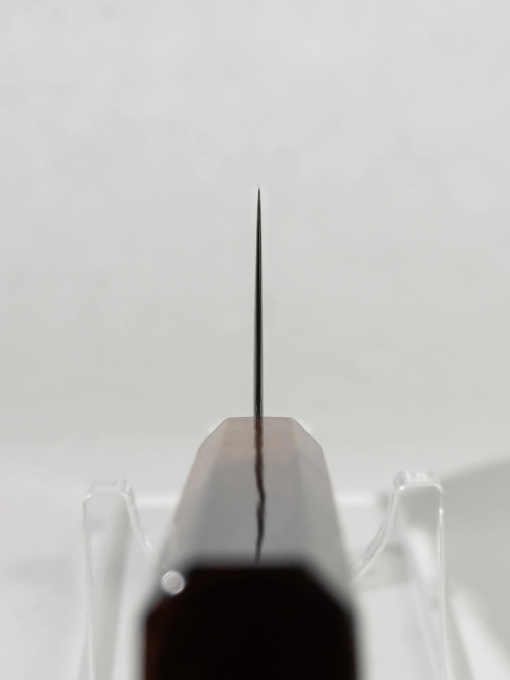 Close-up of the OUL 165mm Uzu Nakiri choil and polished spine showing meticulous craftsmanship.