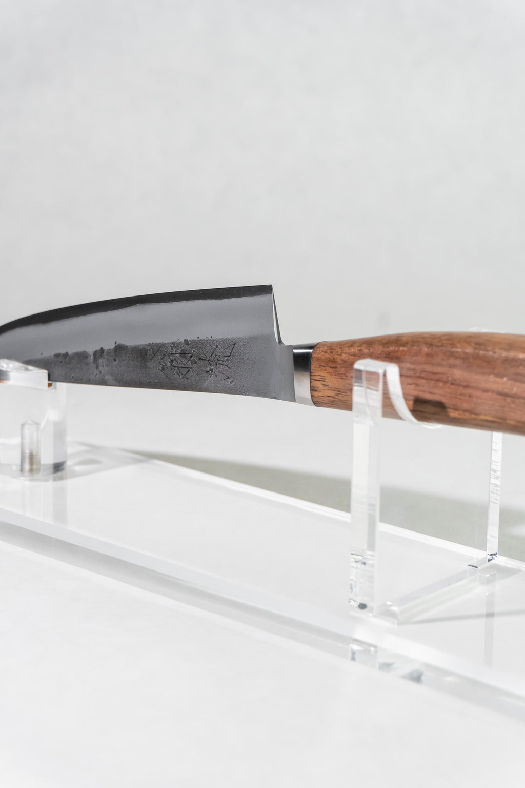 Angled view of OUL petty knife emphasizing balance, thin blade, and traditional Japanese design.