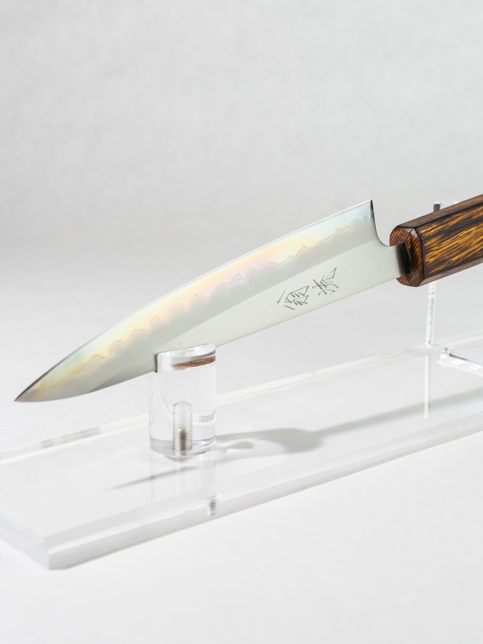 Side profile of OUL 135mm petty knife, showing the full side of the blade, highlighting the gentle, almost  iridescent kasumi.