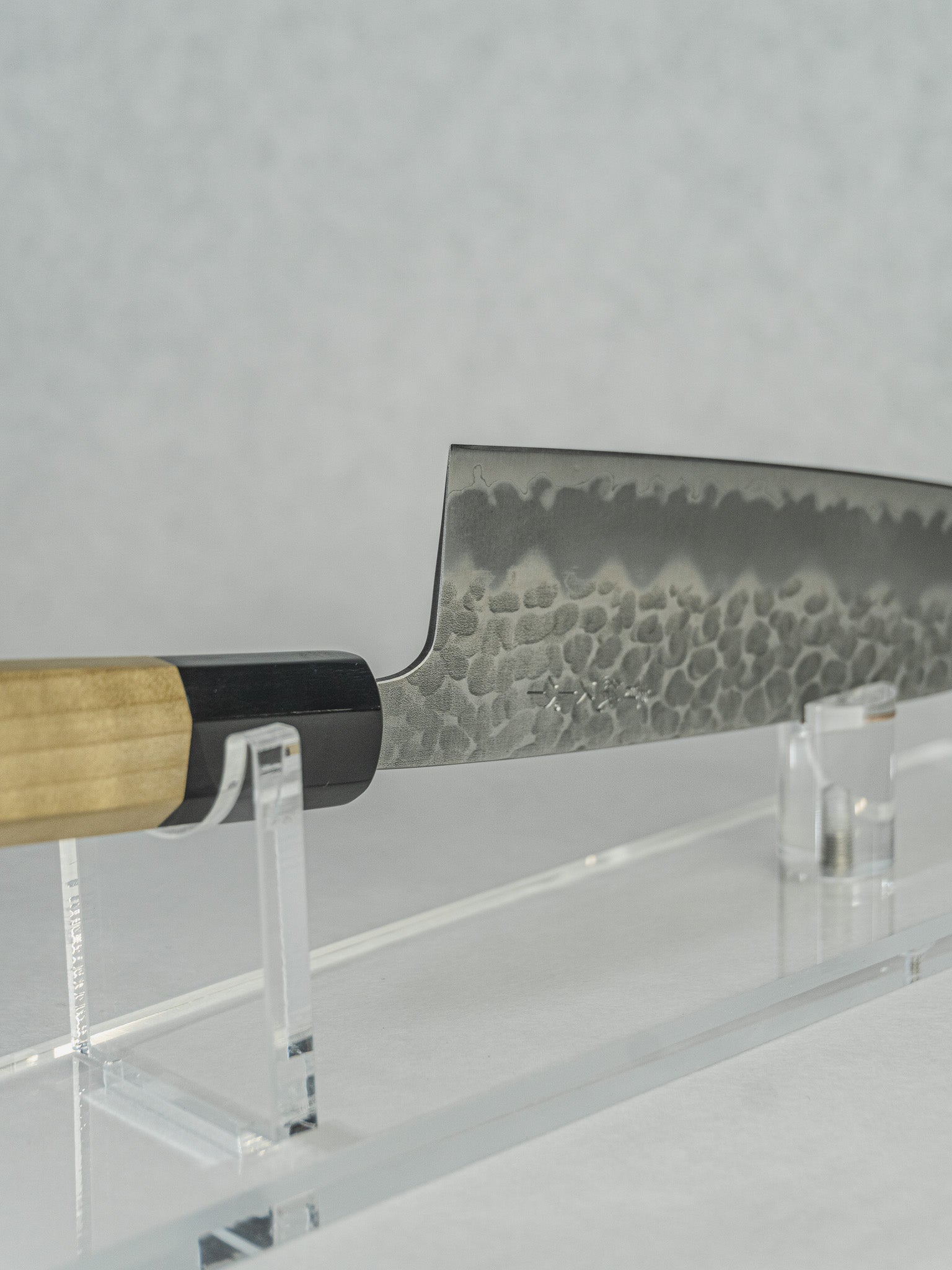 Angled view emphasizing the tsuchime finish, elegant handle materials, and overall balance.