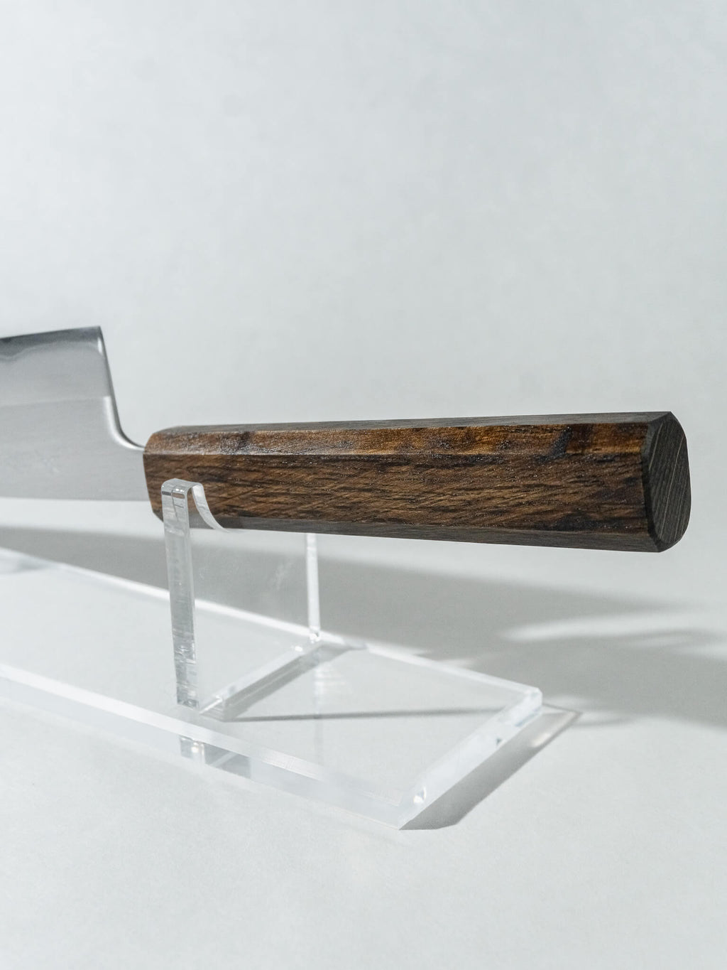 Ergonomic octagonal oak handle of OUL Santoku knife providing balance and comfort in hand