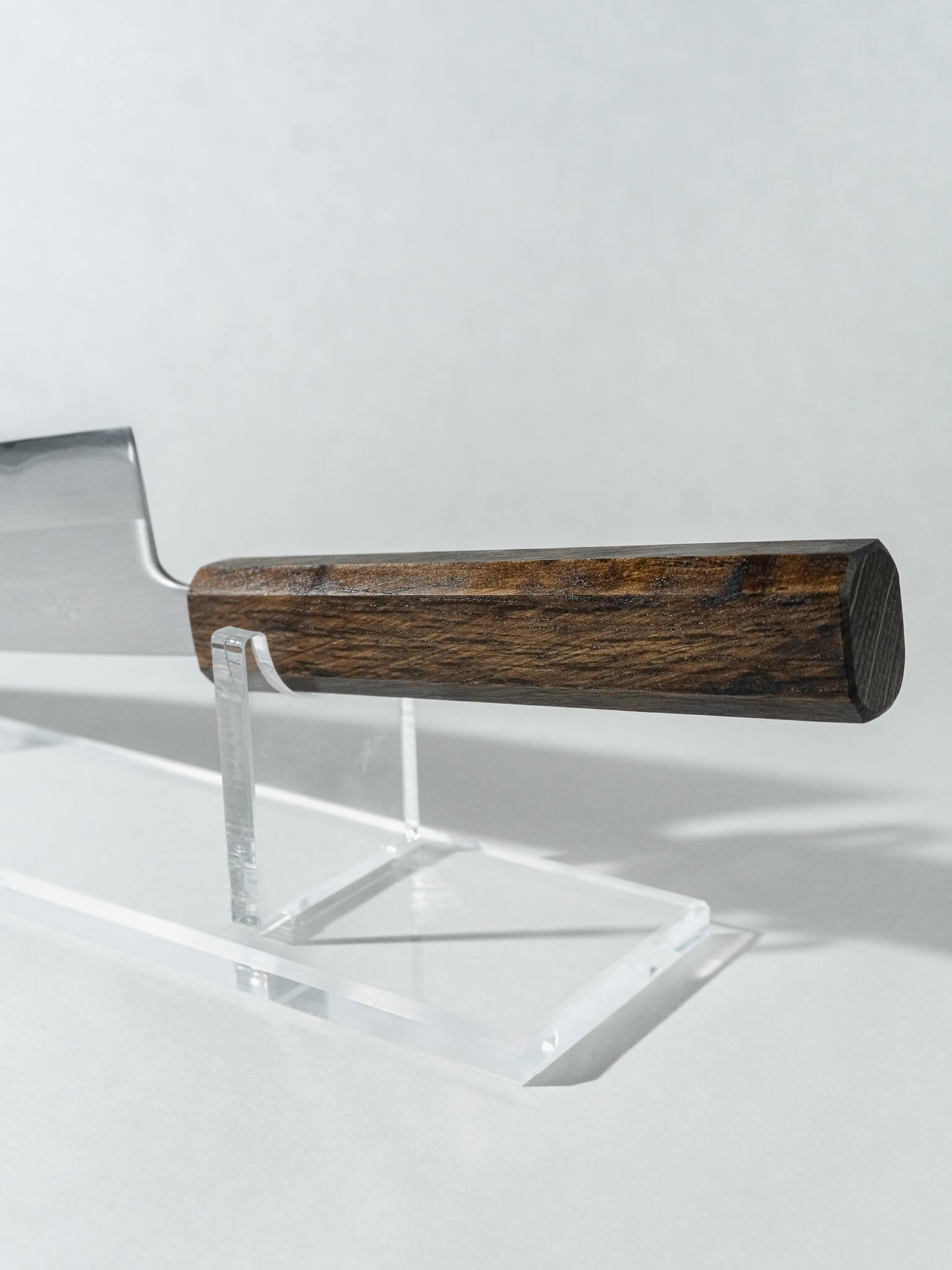 Ergonomic octagonal oak handle of OUL Santoku knife providing balance and comfort in hand