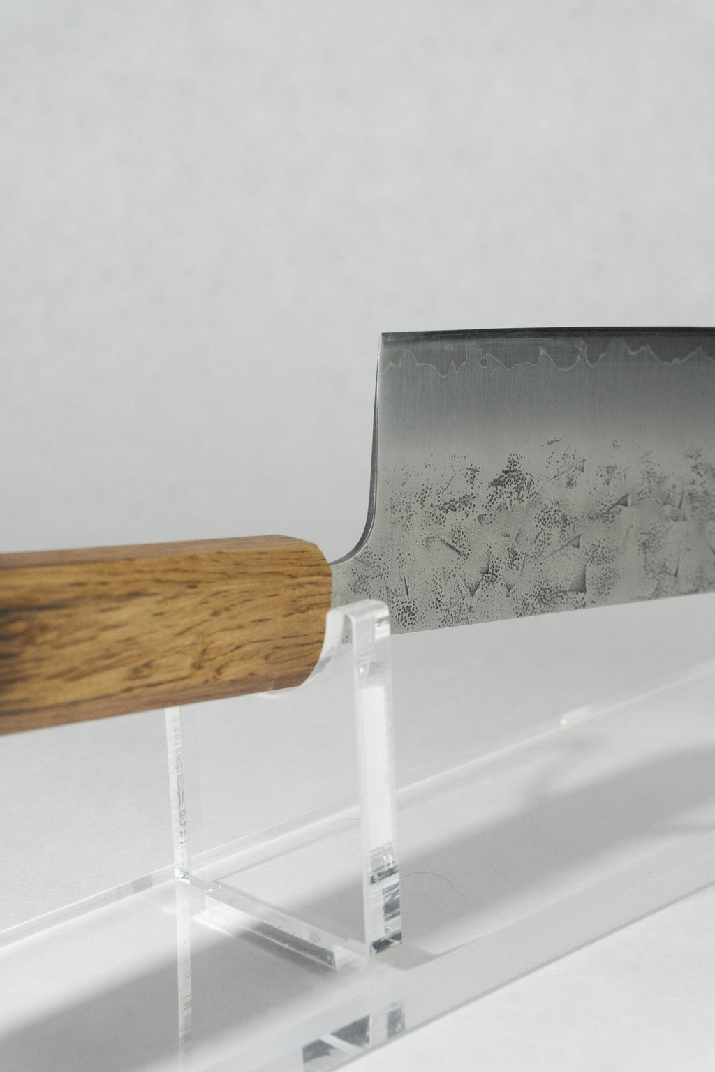 Detail view of where the choil meets the handle showing craftsmanship and smooth transitions for controlled cutting.