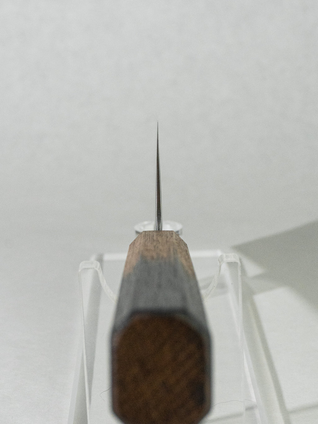 Choil close-up showing the thin geometry of the OUL SLD Nakiri for precise, clean cuts.