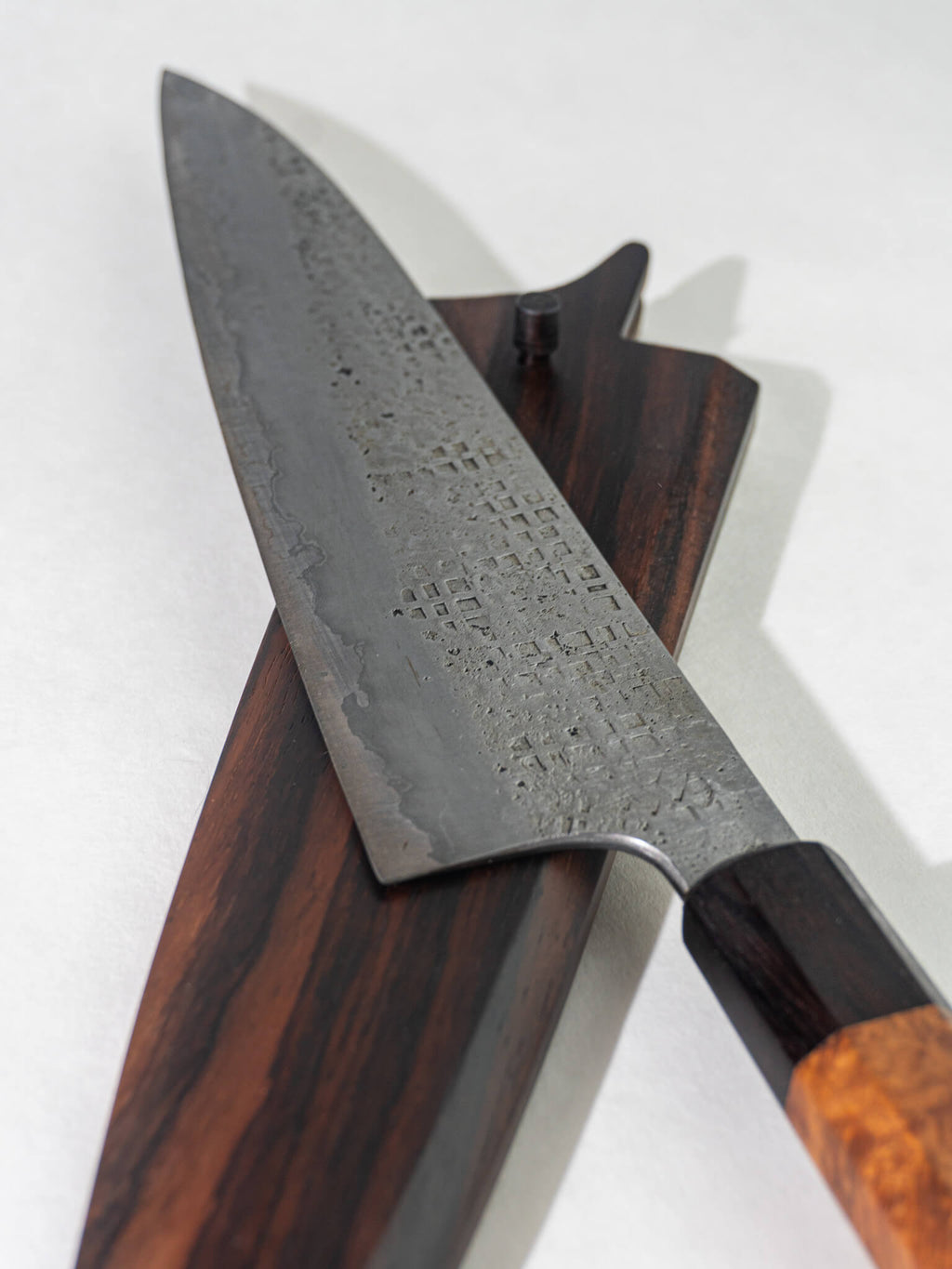 Close up of Pisau Dapur gyuto knife 230mm featuring the unique square hammering pattern on the blade, both rustic and elegant.
