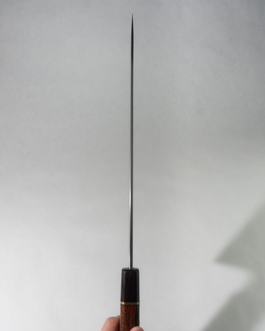 Close-up of the Sakimaru knife blade showing the Honyaki spine detailing and polished edge geometry.