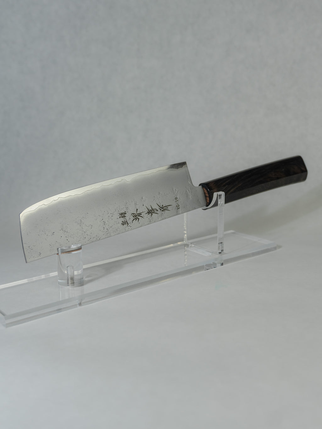 Sakai Takayuki nakiri knife featuring a delicate hammered blade finish for improved food release, paired with an octagonal ebony wood handle for balance and control.