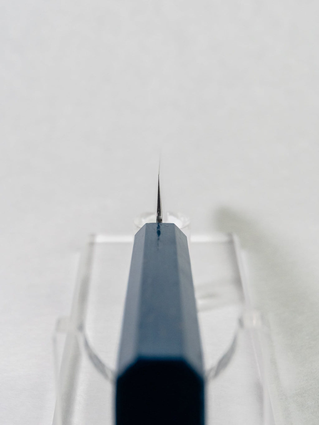 Choil close-up showing thin grind and craftsmanship against a white background