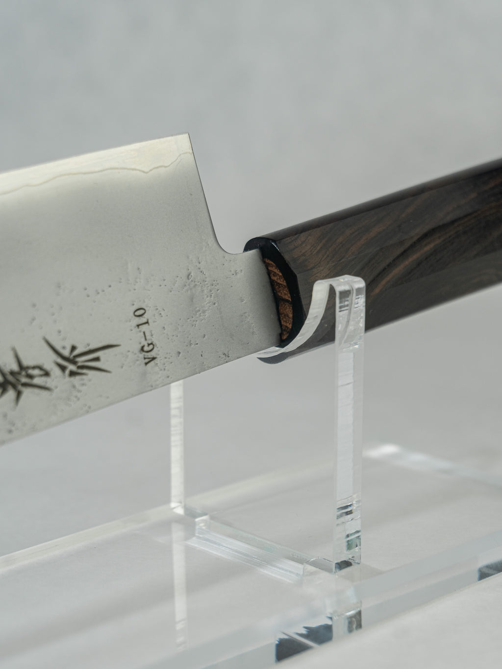 Close-up detail of the nakiri knife’s choil and blade, showcasing the smooth kasumi finish with wave-like patterning along the edge, highlighting the craftsmanship, balance, and layered steel construction.