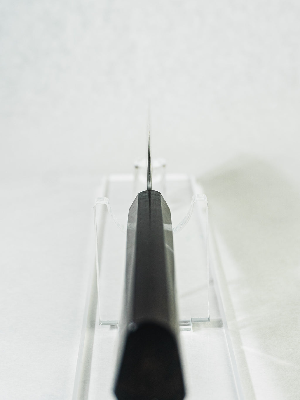 Sakai Takayuki nakiri knife highlighting a close-up view of the octagonal ebony wood handle, choil detail, and the blade’s balanced profile.