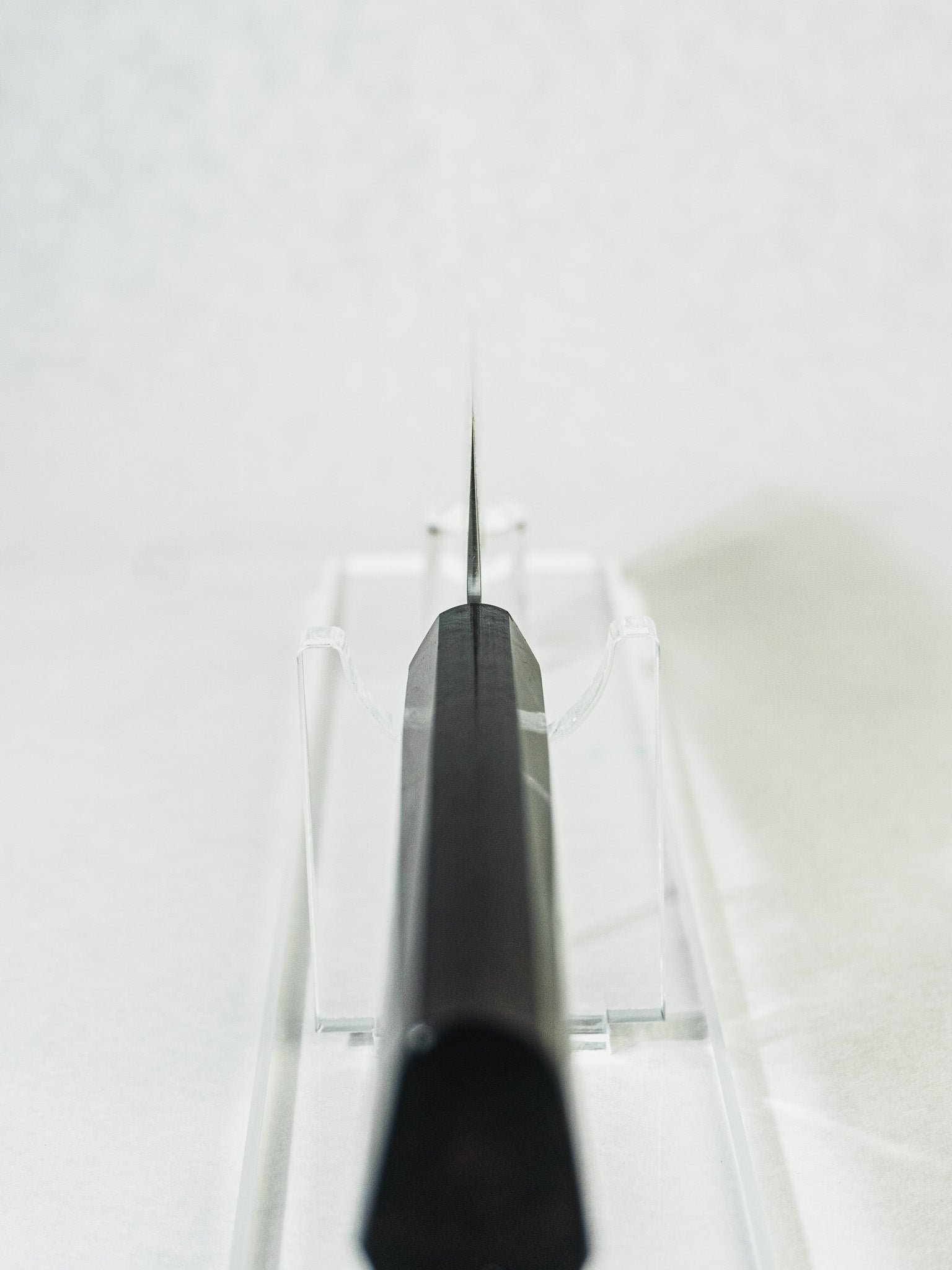 Sakai Takayuki nakiri knife highlighting a close-up view of the octagonal ebony wood handle, choil detail, and the blade’s balanced profile.