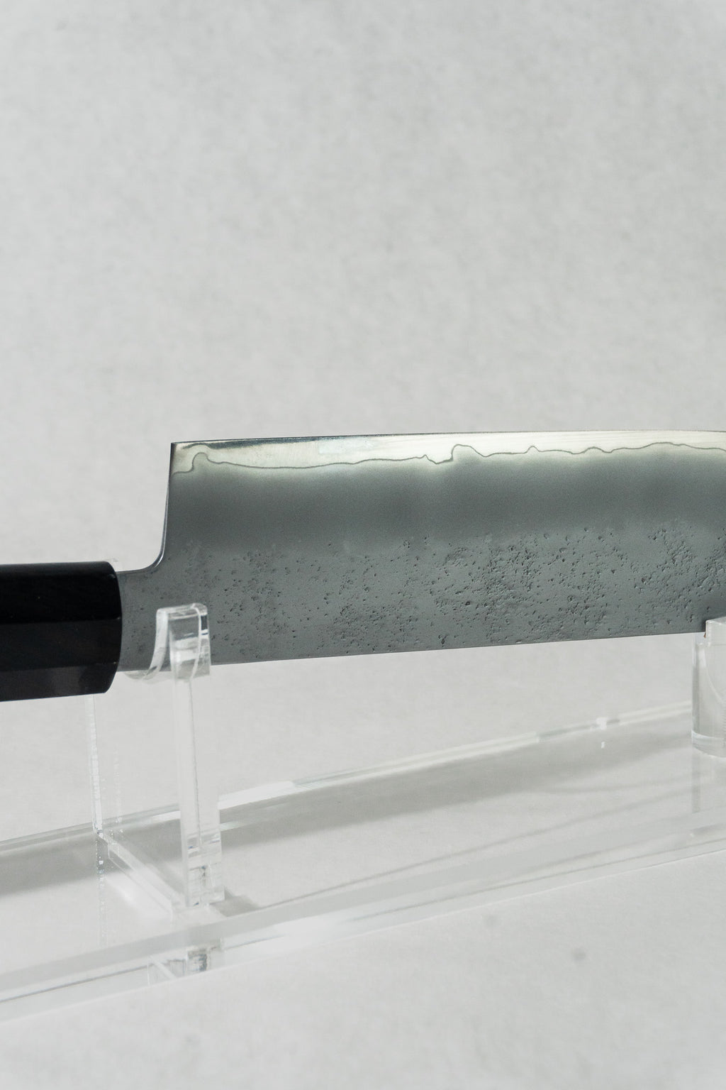 Close up of the nakiri knife, highlighting the beautiful wave-like kasumi patterning along the edge of the blade.