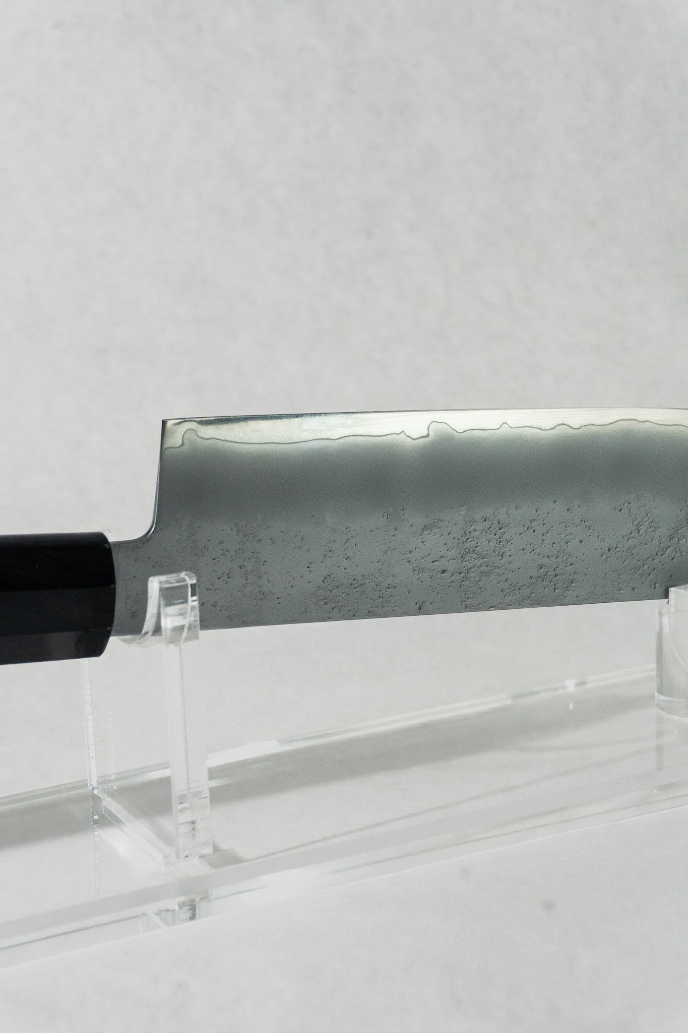Close up of the nakiri knife, highlighting the beautiful wave-like kasumi patterning along the edge of the blade.