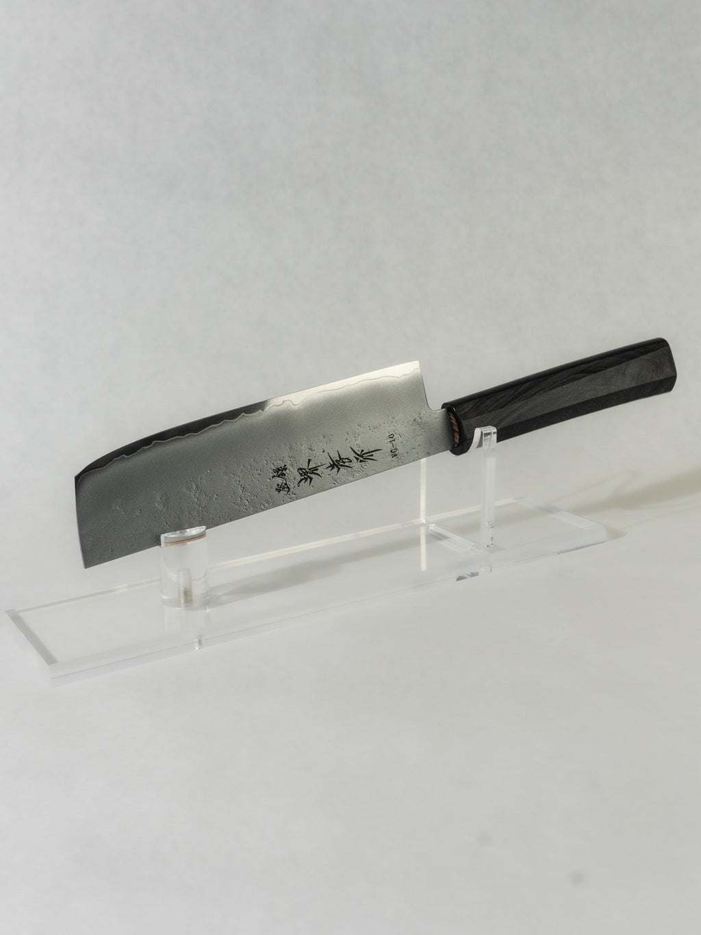 Sakai Takayuki nakiri knife with a delicate hammered blade finish that improves food release, paired with an octagonal ebony wood handle for excellent balance, control, and a refined feel in hand.